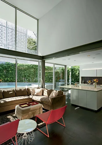 The basalt floor is carried inside to the kitchen and living spaces on the second floor, where it complements bright furnishings.