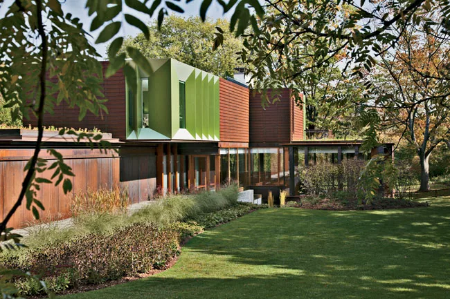 Powder-coated-aluminum panels animate a corner of the top floor and contrast with the adjacent clapboardlike weathered-steel cladding.