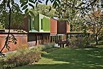 Powder-coated-aluminum panels animate a corner of the top floor and contrast with the adjacent clapboardlike weathered-steel cladding.