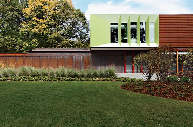 Powder-coated-aluminum panels animate a corner of the top floor and contrast with the adjacent clapboardlike weathered-steel cladding.