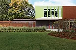 Powder-coated-aluminum panels animate a corner of the top floor and contrast with the adjacent clapboardlike weathered-steel cladding.