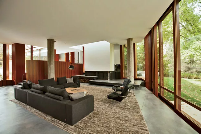 A freestanding mahogany partition directs visitors into the living room.