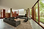 A freestanding mahogany partition directs visitors into the living room.