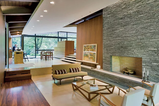 Inside, unpartitioned common areas flow freely from one to the next, delineated only by level changes.