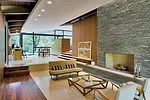 Inside, unpartitioned common areas flow freely from one to the next, delineated only by level changes.