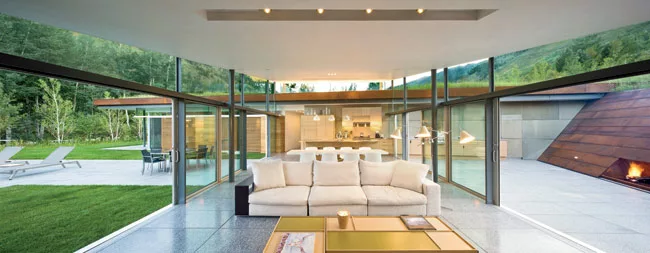 A terrazzo floor of quartz chips and black mortar unites living and dining areas with the terraces outside.