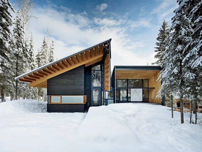 Skiers enter the house on the west and descend stairs fitted with metal treads to the boot room.