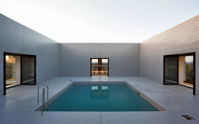 The central pool courtyard provides access to the rooms along the perimeter.