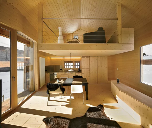  A stair leads to the main level’s living spaces and a mezzanine that doubles as a guest bedroom.