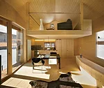  A stair leads to the main level’s living spaces and a mezzanine that doubles as a guest bedroom.