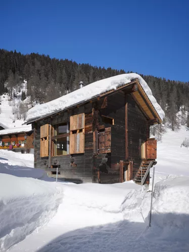 For his firm's first project, Swiss architect Benjamin Krampulz of bkarch converted a former barn into a snug alpine retreat