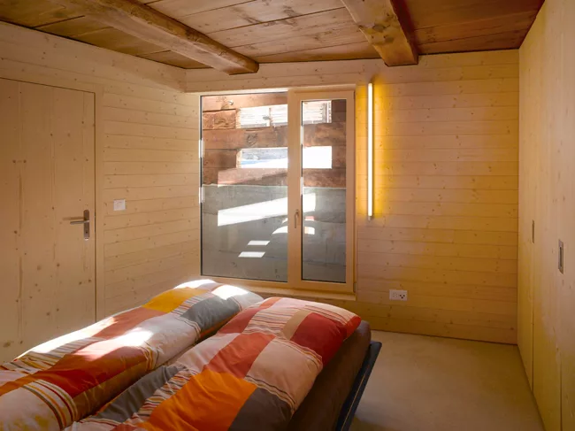 The lower level contains the bathroom, the master bedroom, and storage. The architect brought in light with existing openings, but also added strategic cuts where appropriate.