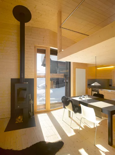 Upstairs, the former hayloft was transformed into living, dining, and kitchen spaces.