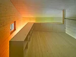 A stair leads to a mezzanine that doubles as a guest bedroom. For panache, the architect stained the fir cladding in acidic hues of green, orange, and yellow.