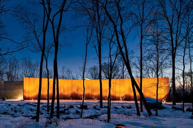 A Cor-Ten steel wall defines the north elevation.