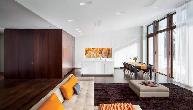 Floor-to-ceiling windows in the bedroom and living room open to sweeping views of the mountains.
