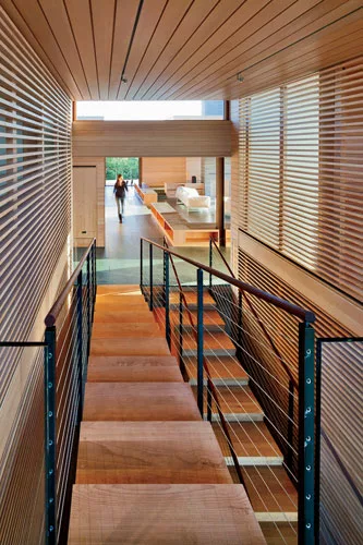 A dramatic stair leads to guest rooms on the lower level of the two-story bedroom wing.