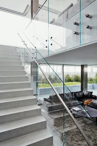 A central glass stair maintains an airy feeling in the living room.