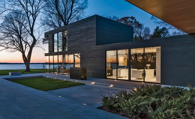 A combined living, dining, and kitchen area has views to the lake, as does the master suite perched on the floor above it.