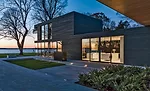 A combined living, dining, and kitchen area has views to the lake, as does the master suite perched on the floor above it.