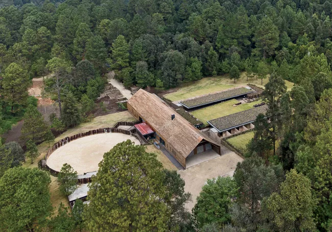 The 30,000-square-foot complex includes a freestanding main house flanked by stables and a riding ring.