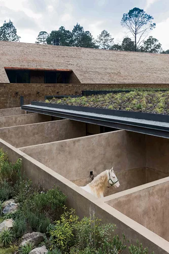 The stables feature outdoor stalls of brick covered in earth and concrete.