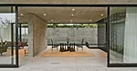 On the main level, sliding glass walls retract to create a seamless at-grade transition between indoors and out.