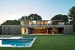 The heavily glazed south facade includes over 30 feet of sliding glass doors on the ground floor that open completely to an outdoor deck and rear yard.