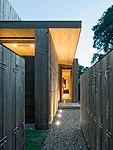 The layered entry sequence on the north side acoustically insulates the house.