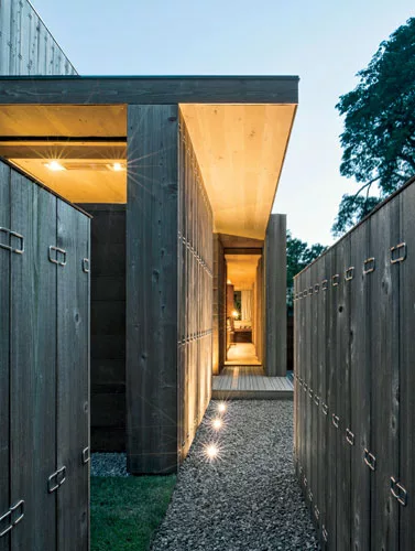 The layered entry sequence on the north side acoustically insulates the house.