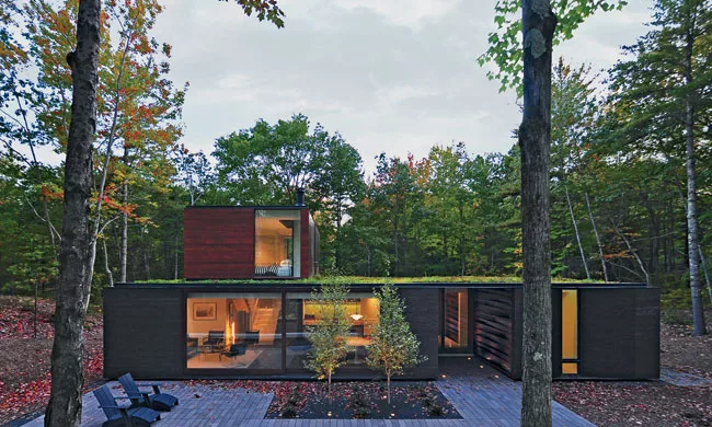 The living and dining areas along the north side of the house adjoin a covered porch lined in board-and-batten.