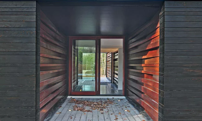 Covered porch lined in board-and-batten.