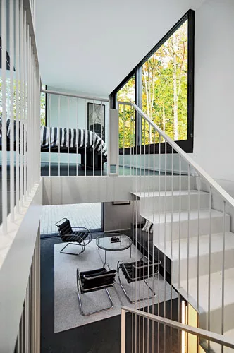 Inside, a white steel stair leads to the studio.