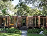 Red cedar folding shutters extend across the house's front facade.  