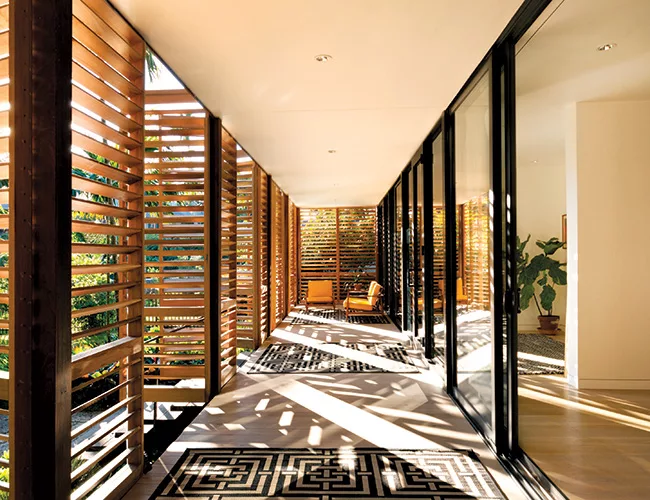 The screen masks a 50-foot-long porch that repeats along the rear.