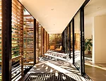 The screen masks  a 50-foot-long porch that repeats along the rear. 