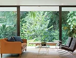 Inside, the open-plan interior has expansive views of the jungle-like setting.
