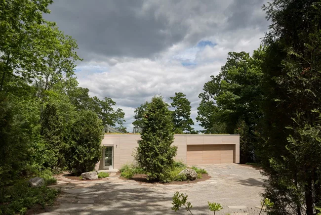 Entrance to garage and guest accommodations at the top of the slope.