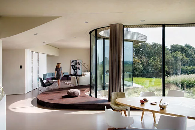 The curvilinear dining and living spaces wrap around a podium.