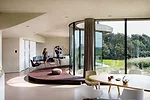 The curvilinear dining and living spaces wrap around a podium.