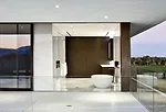 Deep terraces outside the master baths reinforce the horizontal planes of the house. Bronzed anodized aluminum frames the openings. 
