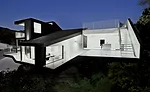 The architects used the difficult hillside site to create a range of outdoor spaces on different levels.