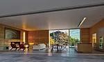 Sliding glass panels on two sides open the living pavilion to views and patios. The rammed-earth walls, which took four months to build, combine earth, cement, and dye. 