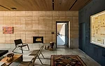 The music room was acoustically engineered to work as a professional recording studio and has a Murphy bed in the wall opposite the fireplace so it can also serve as a guest suite. The clients hope it