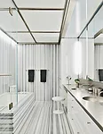 Heavily veined Linac marble gives a second-floor bathroom graphic visual punch.