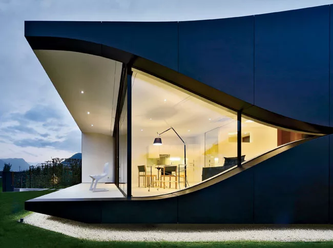 The roof's spline curve, a favorite of architects fluent in parametric design, and the smile-like curves of the two sides add a sensual touch to the more rigid geometry of the front and back.