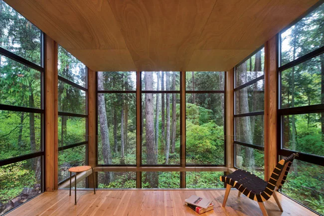A dropped hemlock ceiling for the mezzanine level amplifies the verticality of the trees.