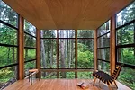 A dropped hemlock ceiling for the mezzanine level amplifies the verticality of the trees.