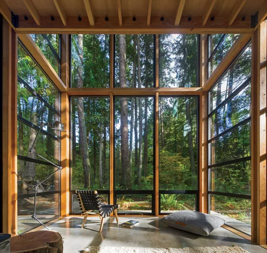 The owner and his family have a private view of the woods from the living room.