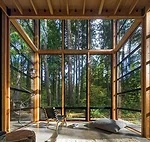 The owner and his family have a private view of the woods from the living room.